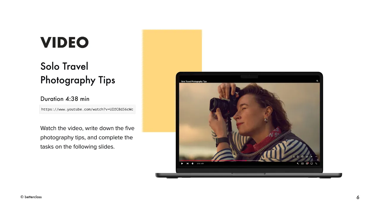 A photography B2 lesson: laptop playing a "Solo Travel Photography Tips" video with a woman adjusting her camera outdoors.