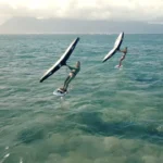 Two women wing foiling above the ocean in Maui, featured in a B2 lesson plan about aging, passion, and staying active in life.