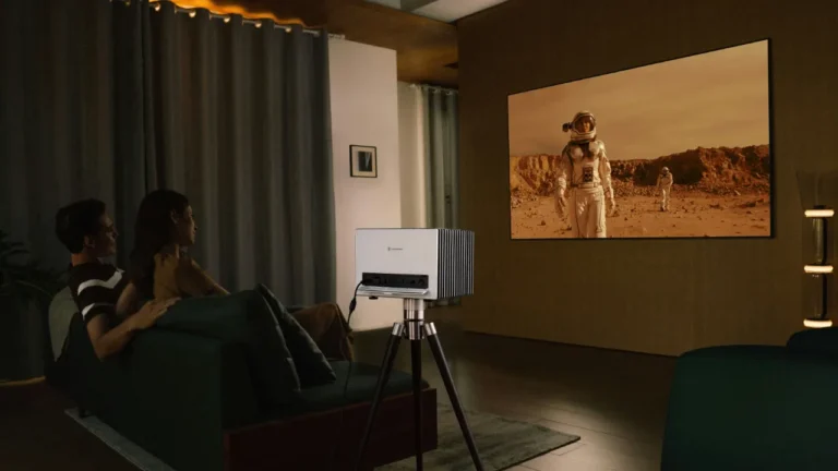 A couple watching a sci-fi movie at home with a projector — movies A2 lesson on film genres and movie night habits.