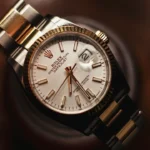 A gold and steel Rolex Datejust catches warm, dramatic light against a dark background, the cover for this vintage watch lesson.