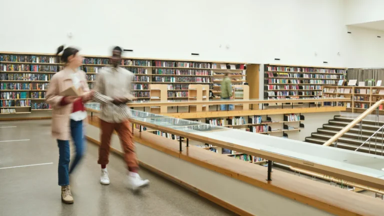 Blurred figures rush past library shelves, capturing the fast pace this A2 lesson on daily routine slows down to examine.
